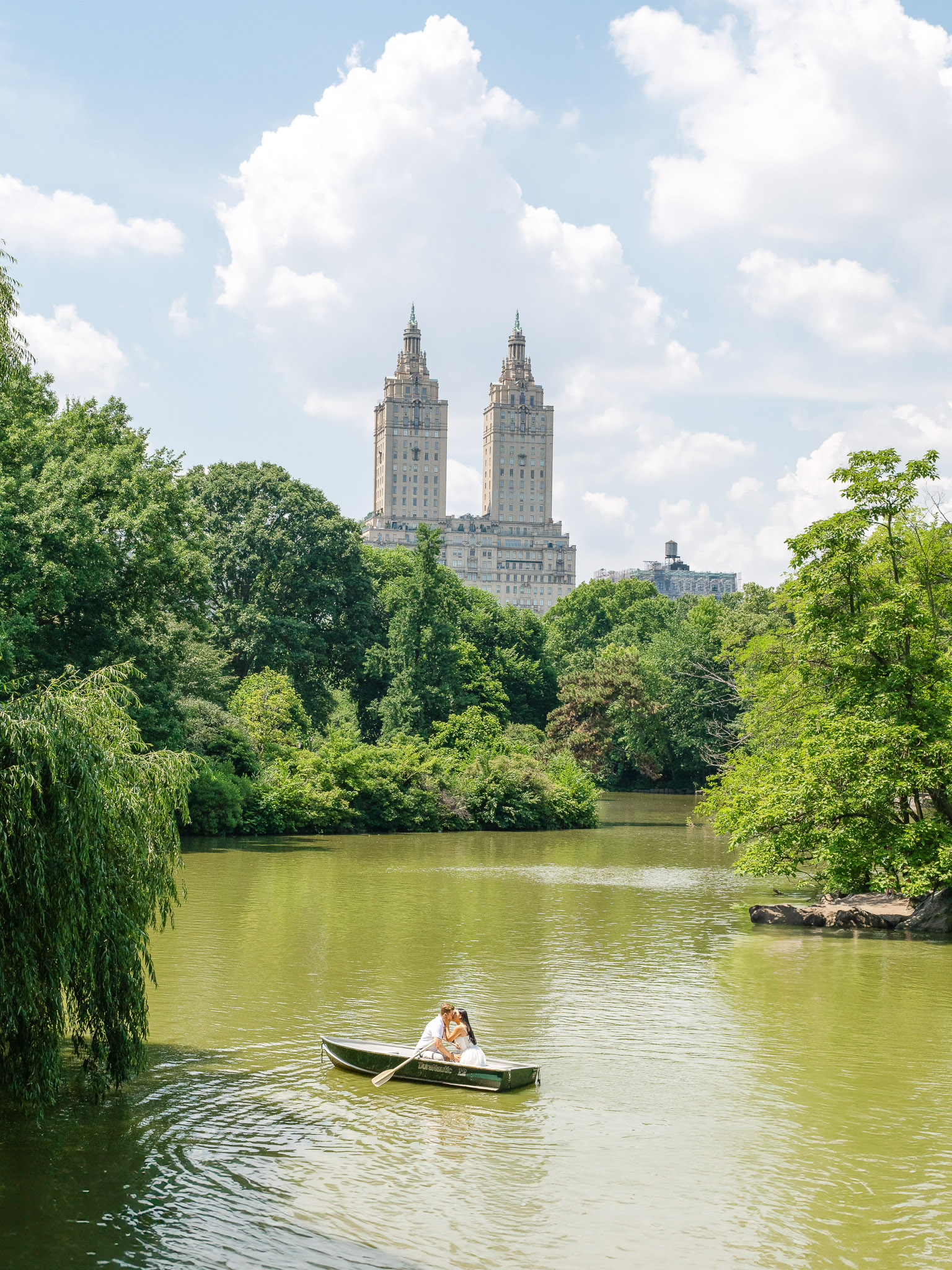 A romantic engagement summer boat ride in Central Park in New York City